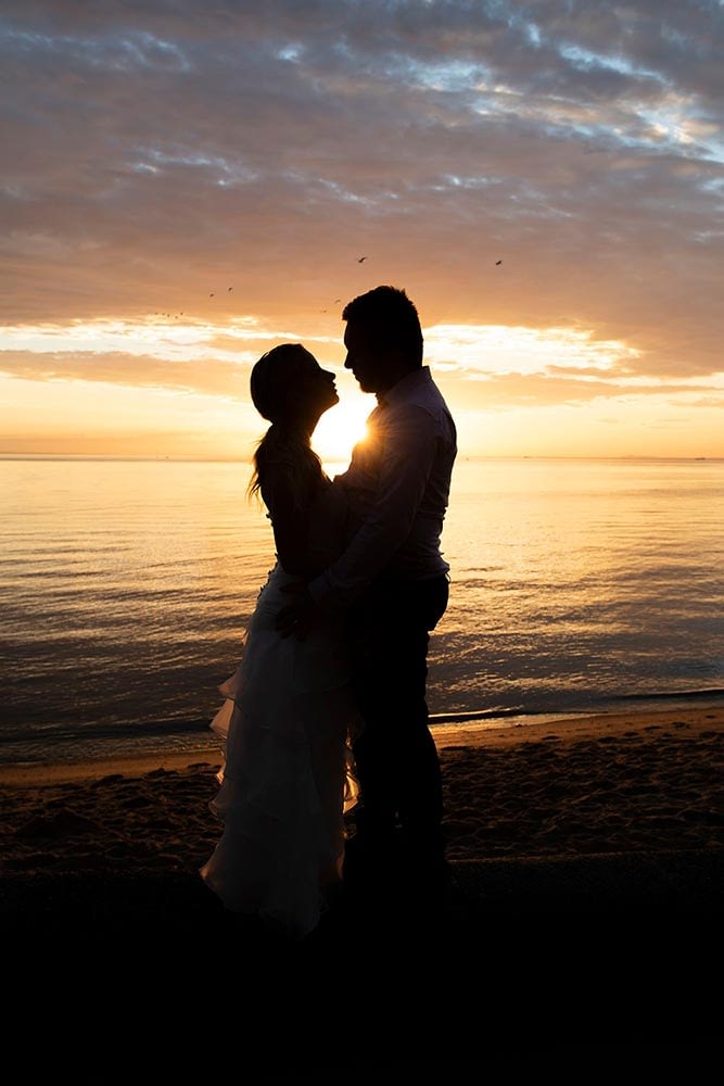 photo of bride and groom at sunset