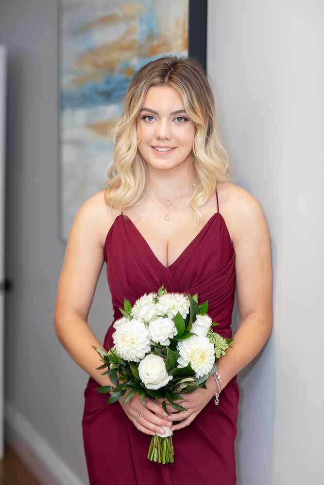 beautiful bridesmaid holding flowers