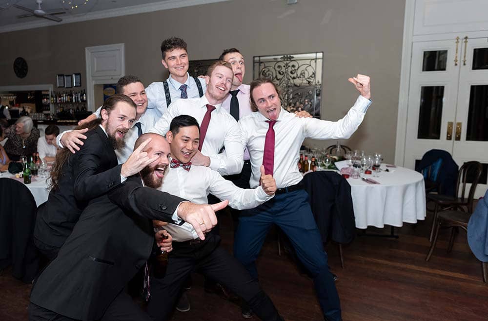 natural moment of group photo at wedding reception