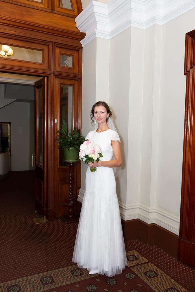 bride holding flowers inside old treasury building