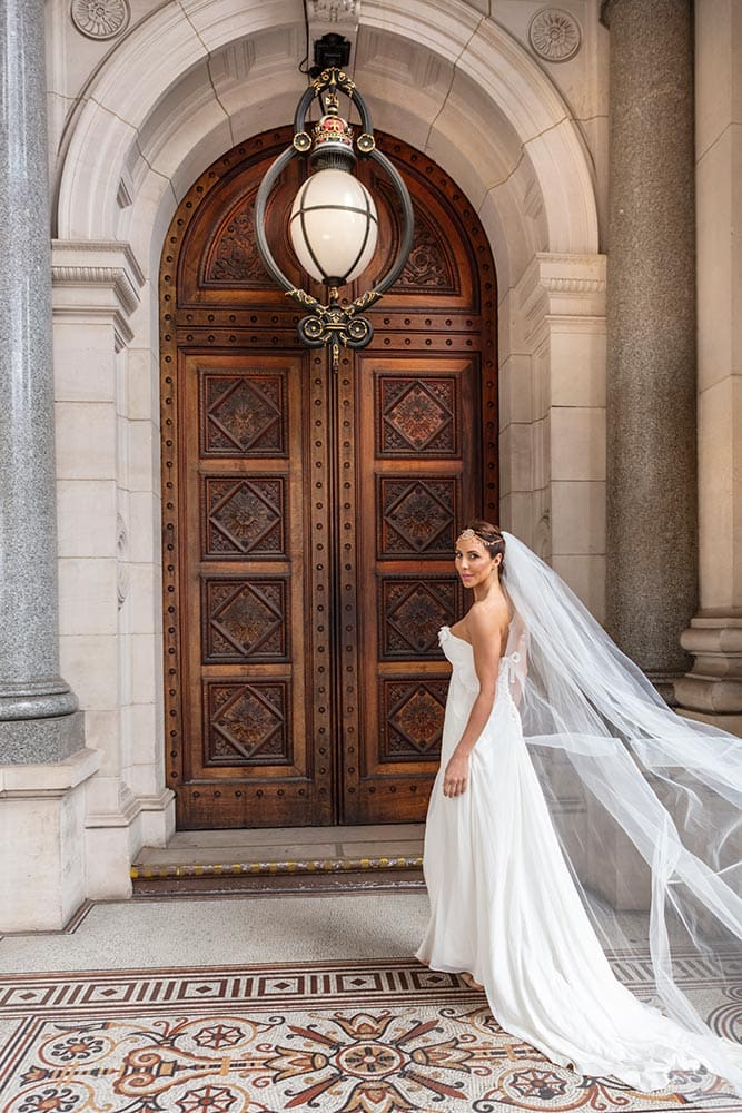 Bride walking toward the parliament house door.